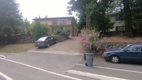 Passenger-point-of-view-while-driving-on-Island-Highway-through-suburban-Victoria,-BC