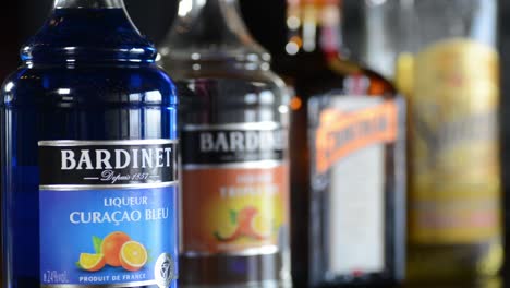 Alcoholic-spirits-and-liqueurs-on-shelf,-Bardinet,-Cointreau-and-Sauza,-rack-focus