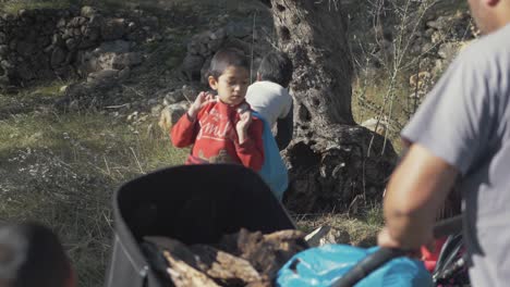 Afghan-boy-refugee-stands-with-bag-of-timber-over-shoulder