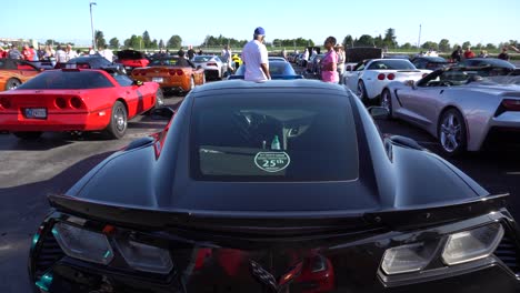 Various-generations-and-trim-levels-of-Corvettes-parked,-all-viewed-after-a-pan-up-from-a-seventh-gen-z06