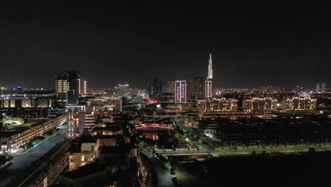 Aerial-crane-shot-at-night-of-new-luxury-residential-development-along-the-Saigon-River-in-District-two-of-Ho-Chi-Minh-City,-Vietnam