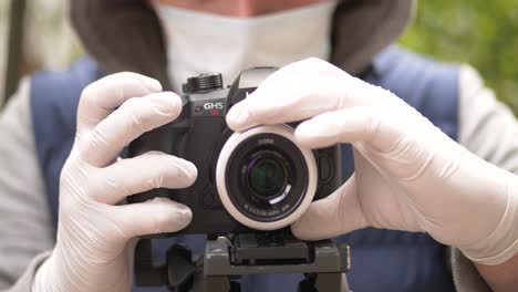 Man-wearing-mask-and-gloves-shoots-video-on-coronavirus-pandemic-crisis