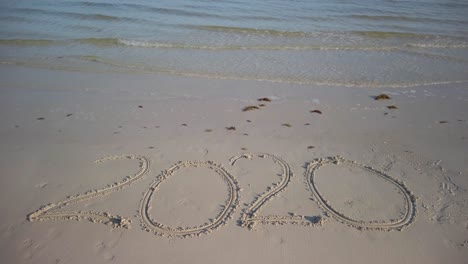 Twenty-Twenty-inscription-in-the-sand-on-a-beach