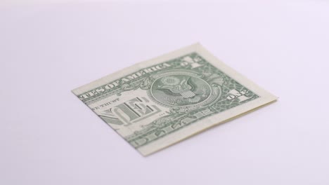 one-dolar-rotate-on-white-background-in-photo-studio