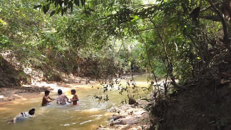 Children-Playing-in-the-River-Surrounded-by-Trees