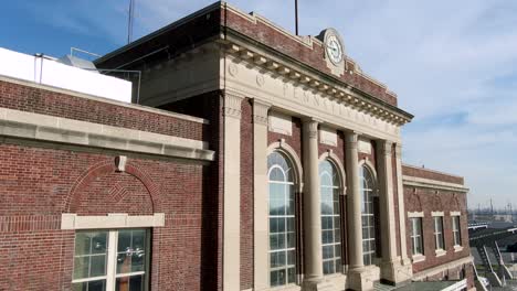 Aerial-of-Lancaster-Train-Station,-historic-brick-building-and-facade-on-sunny-day