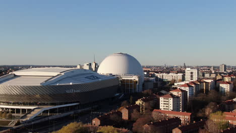 Panoramic-aerial-rise-focusing-on-sunlit-Ericsson-Globe-in-Stockholm