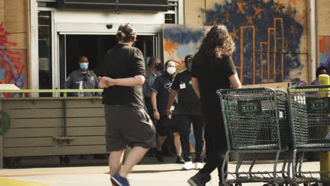 Security-guards-and-people-in-face-masks-outside-shop,-BLM-black-lives-matter-protest