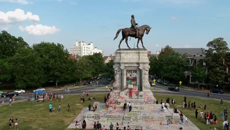 Drone-backing-reveals-group-of-people-demonstrating,-protesting-racial-discrimination-and-police-brutality