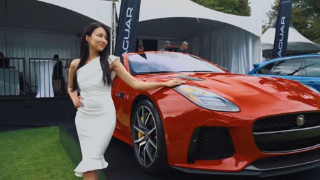 Beautiful-Woman-Modeling-Next-to-a-Jaguar-Superleggera-at-Car-Show