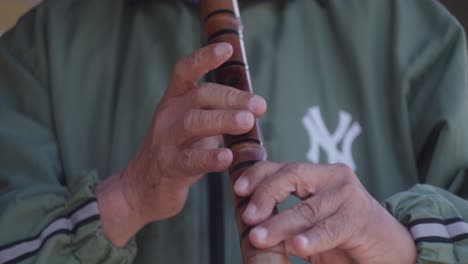 Aged,-elderly-male-senior-playing-on-bamboo-flute-in-Taiwan