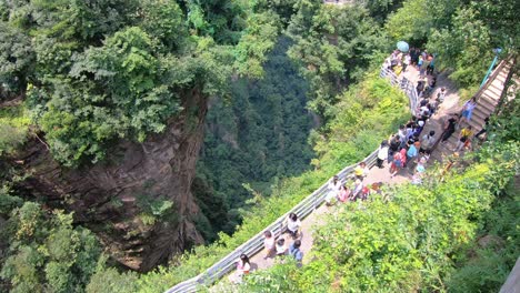 Multitudes-De-Turistas-Caminando-Por-El-Sendero-Panorámico-En-El-Mirador-Del-Puente-Natural-Más-Grande,-También-Conocido-Como-Puente-Aéreo-Tian-Qiao,-Parque-Natural-De-Las-Montañas-Avatar.