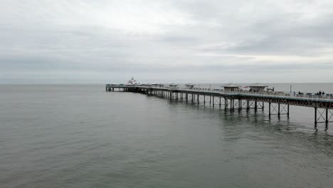 Landmark-seaside-old-Llandudno-Victorian-pier-promenade-panorama-pan-right