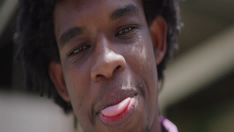 Young-African-American-Male-Smiles-at-Camera-in-Slow-Motion,-Close-Up