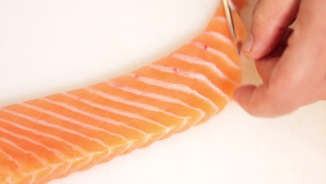 Chef-Filleting-A-Fresh-Salmon-For-Sushi-Dish-On-A-Chopping-Board