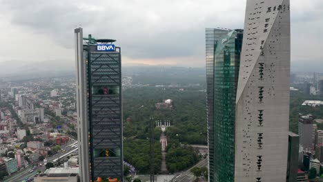 Aerial-view-of-Torre-BBVA-,-Torre-Mayor-overlooking-Bosque-de-Chapultepec-Park-,-Chapultepec-castle-,-Mexico-city-with-cloudy-sky