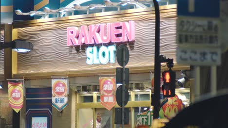 Storefront-Of-A-Pachinko-Slot-Machine-Near-The-Traffic-Lights---Gambling-Centre-At-Night-In-Tokyo,-Japan