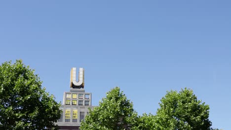 Dortmunder-U-building,-against-blue-sky-with-covid19-message