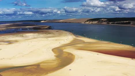 The-Banc-d'Arguin-at-Arcachon-Bay-France-with-Pilat-Dune-and-boats-in-the-background,-Aerial-dolly-left-view