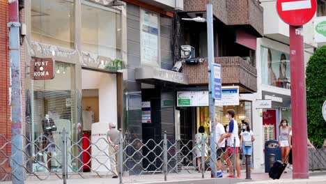 Locked-shot-of-Tourists-with-protective-masks-due-to-coronavirus-walking-in-Alicante,-Spain