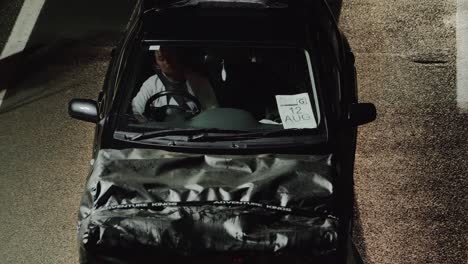 Female-Driver-Waiting-Inside-The-Car-At-The-Checkpoint---Qld-NSW-Border-In-Australia---Covid-19-Safe-Travel---high-angle-shot