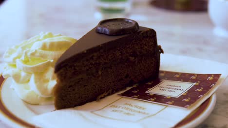 Slow-Motion-of-Famous-and-Delicious-Sacher-Cake-with-Cream-in-Austria