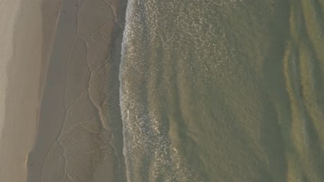 Dreamy-rolling-waves-on-seashore-Aerial-ascending-view