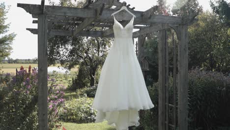 Backyard-garden-patinaed-pergola-garden-with-a-wedding-gown-hanging-from-the-pergola-at-the-Strathmere-Resort-and-Spa-in-Ottawa,-Canada