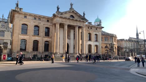 Una-Vista-De-Ciclistas-Y-Peatones-En-La-Calle-Ancha-Frente-Al-Edificio-Clarendon-En-Oxford,-Inglaterra