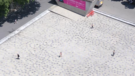 birds-eye-view-of-town-square-at-castle-Bellinzona-Switzerland,-few-people-walking-alone