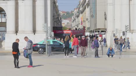 A-close-view-of-The-Rua-Augusta-Arch-historical-building-and-visitor-in-Lisbon,-Portugal