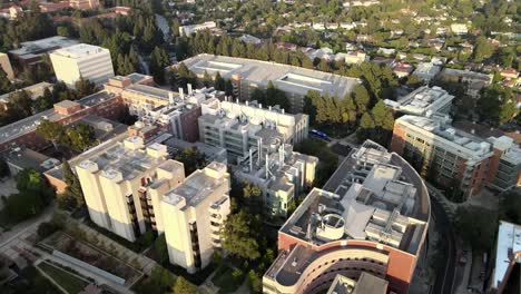 Flying-aerial-over-UCLA-campus-buildings,-clear-sunny-day