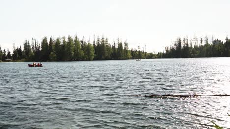 Small-boats-are-moving-across-the-mountain-lake-with-gentle-wind-breeze