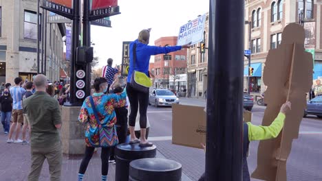 People-celebrating-Joe-Biden's-election-victory-in-the-streets-of-Boulder,-Colorado