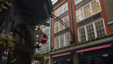 Smooth-slow-motion-gimbal-pan-around-Green-King-Pub-revealing-Carnaby-Street's-entrance-sign,-London