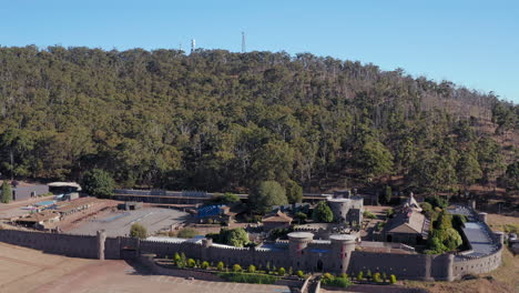 Aerial-view-towards-the-Kryal-Castle,-sunny-day,-in-Australia---approaching,-pan,-drone-shot