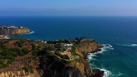 Drone-shot-flying-away-from-huge-mansions-on-a-cliff-in-Laguna-Beach-California-which-is-near-Newport-Ca