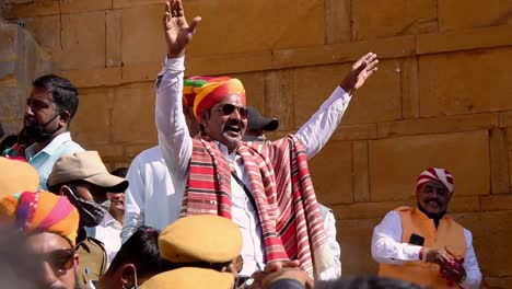 men-wearing-colorful-turban-and-shawl-cheering-people-on-the-occasion-of-coronation-ceremony-of-the-king