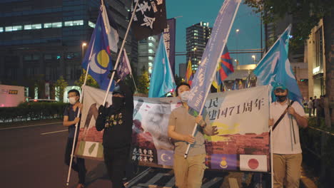 Uyghurs,-Tibetans,-And-Hong-Kongers-At-Joint-Protest-Against-Communist-Party-of-China-Held-In-Street-Of-Tokyo,-Japan-At-Night