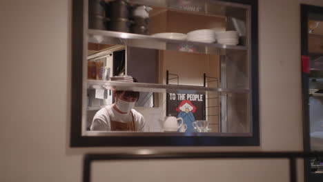 Japanese-Woman-In-Mask-Working-In-The-Restaurant-Kitchen