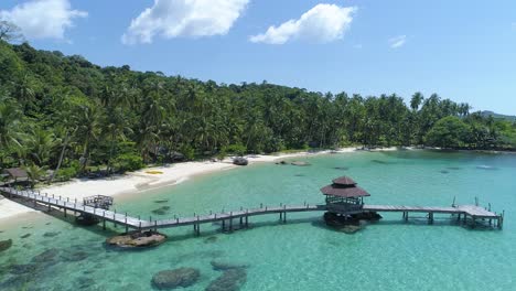 Aerial-of-pier-out-in-the-ocean-on-a-perfect-tropical-island,-Koh-Kood,-Thailand