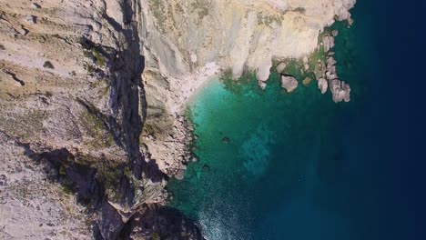 Aerial-top-down-view-of-hidden-cove-with-turquoise-clean-water