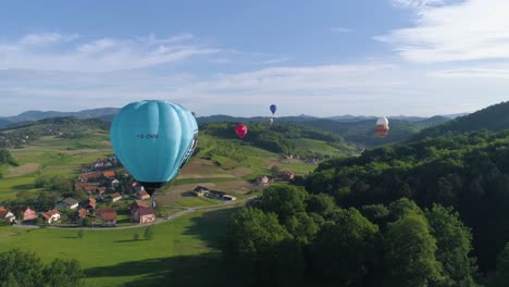 Aerial-shot-flying-towards-hot-air-balloon-with-others-in-the-distance