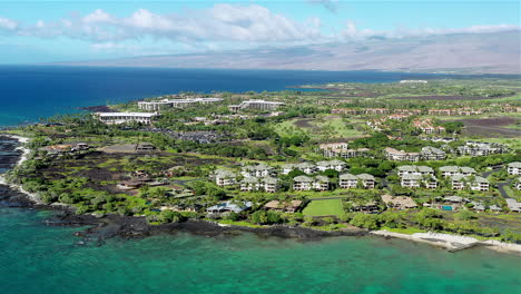 Drone-footage-of-the-Ocean,-condos,-and-housing-along-the-coast-of-the-Big-island-of-Hawaii