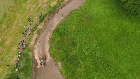 Offroad-mud-rally-with-buggy-in-forests-and-river-aerial-view