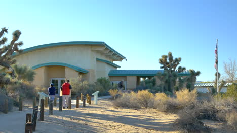 The-Elyze-Clifford-Interpretive-Center-building-with-local-residents-enjoying-a-walk-through-the-Prime-Desert-Woodland-Preserve-in-Lancaster,-California