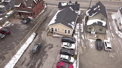 Drone-shot-of-a-small-parking-lot-in-the-winter