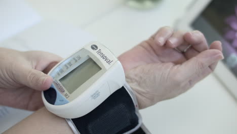 Alte-Frau-Mit-Einem-Digitalen-Blutdruckmessgerät