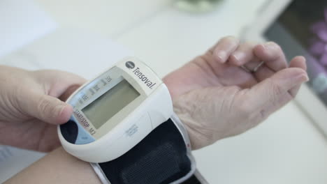 Old-Woman-Using-A-Digital-Sphygmomanometer