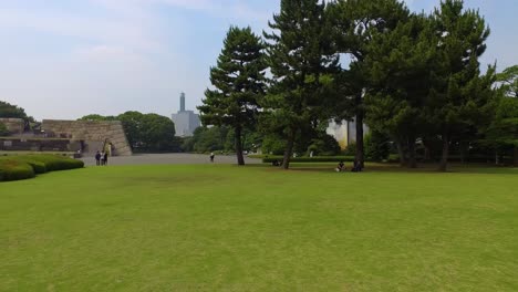 Pan,A-view-from-Royal-Palace-garden-to-city-with-people-walking